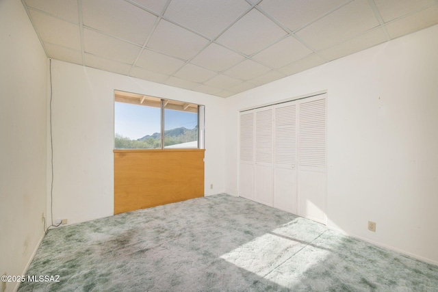 6532 N Cibola Ave, Tucson, AZ 85718 - unfurnished bedroom with carpet flooring, a paneled ceiling, and a closet