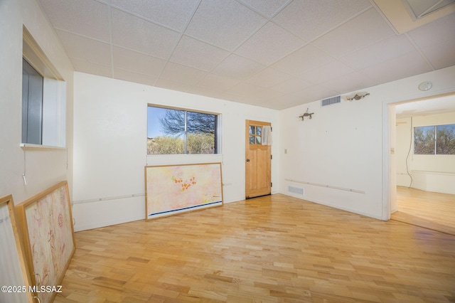 6532 N Cibola Ave, Tucson, AZ 85718 - empty room featuring a paneled ceiling, light wood-type flooring, baseboards, and a smoke detector
