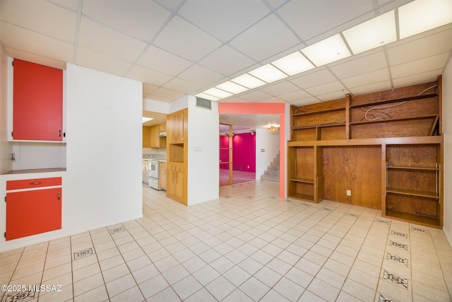 6532 N Cibola Ave, Tucson, AZ 85718 - unfurnished room featuring a drop ceiling, built in features, and light tile patterned floors