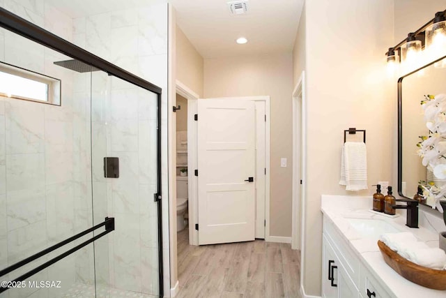 3601 E Nebraska Stra, Tucson, AZ 85706 - bathroom featuring a stall shower, double vanity, wood finished floors, and recessed lighting