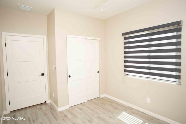3601 E Nebraska Stra, Tucson, AZ 85706 - unfurnished bedroom featuring a closet and light wood-style flooring