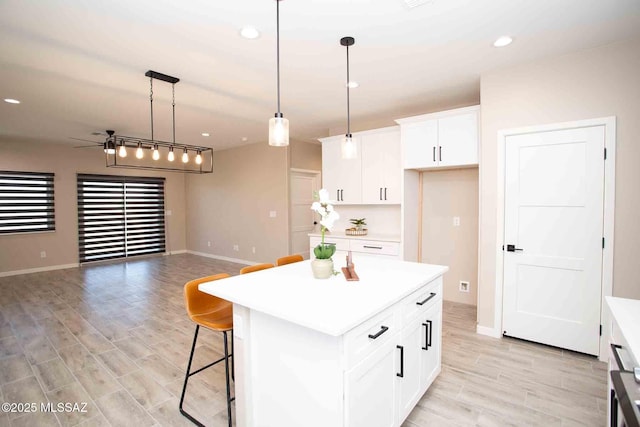 3601 E Nebraska Stra, Tucson, AZ 85706 - kitchen featuring light countertops, light wood-type flooring, a center island, open floor plan, and recessed lighting