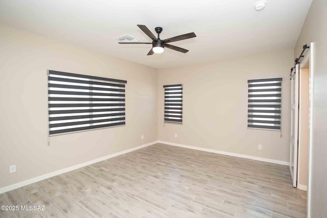 3601 E Nebraska Stra, Tucson, AZ 85706 - empty room with a barn door, a ceiling fan, wood finished floors, and a smoke detector