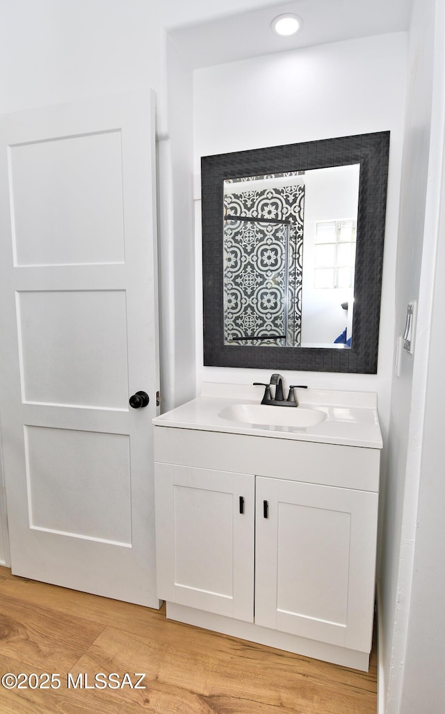 4038 E Bellevue St, Tucson, AZ 85712 - bathroom featuring vanity, recessed lighting, and wood finished floors