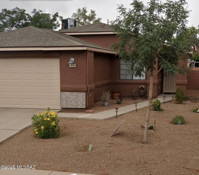 1643 W Houchin Way, Tucson, AZ 85746 - view of front facade featuring roof with shingles, driveway, a garage, and stucco siding