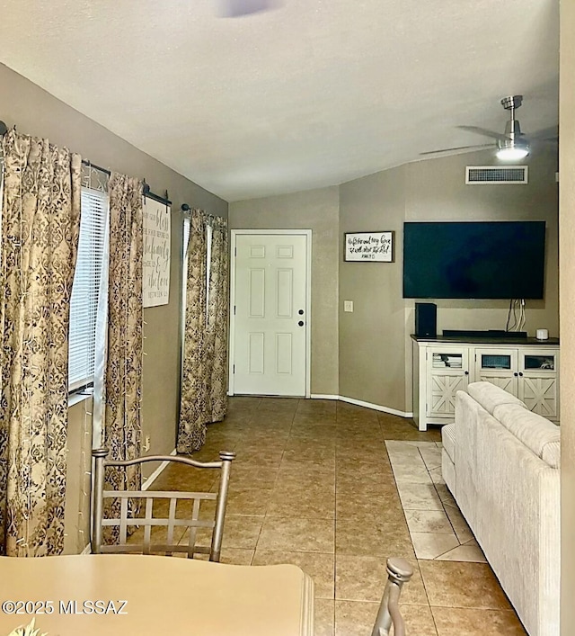 1643 W Houchin Way, Tucson, AZ 85746 - unfurnished living room with tile patterned flooring, a ceiling fan, and vaulted ceiling