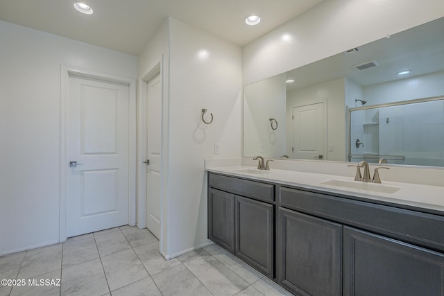 662 N Tree Mist Ln, Sahuarita, AZ 85629 - bathroom featuring double vanity, an enclosed shower, tile patterned floors, and recessed lighting