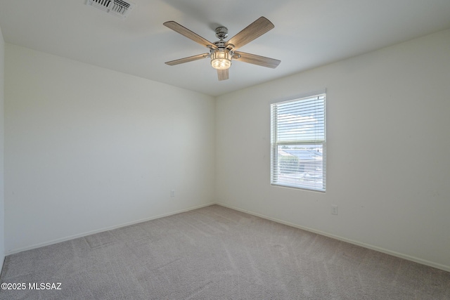 662 N Tree Mist Ln, Sahuarita, AZ 85629 - spare room featuring light carpet, a ceiling fan, and baseboards