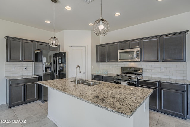 662 N Tree Mist Ln, Sahuarita, AZ 85629 - kitchen featuring black appliances, a sink, tasteful backsplash, light stone counters, and an island with sink