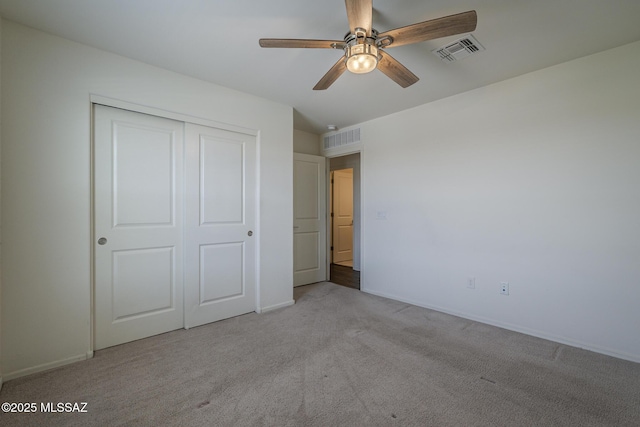 662 N Tree Mist Ln, Sahuarita, AZ 85629 - unfurnished bedroom with carpet flooring, a closet, a ceiling fan, and baseboards
