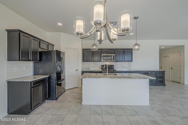 662 N Tree Mist Ln, Sahuarita, AZ 85629 - kitchen with appliances with stainless steel finishes, a kitchen island with sink, a sink, decorative backsplash, and recessed lighting