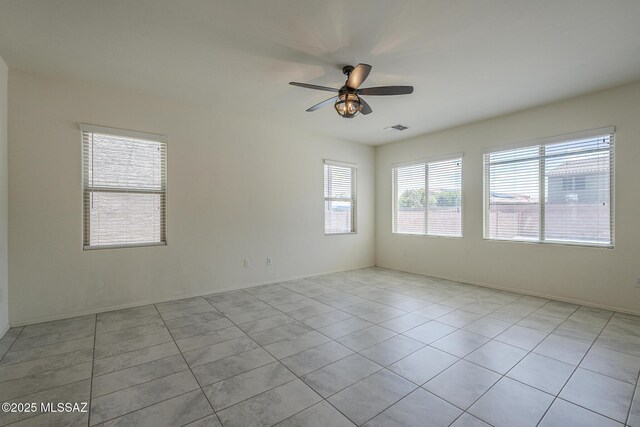 662 N Tree Mist Ln, Sahuarita, AZ 85629 - empty room featuring a ceiling fan, light tile patterned floors, and baseboards