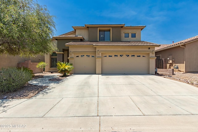 7397 W Crimson Ridge Dr, Marana, AZ 85743 - view of front facade featuring stucco siding, an attached garage, and driveway