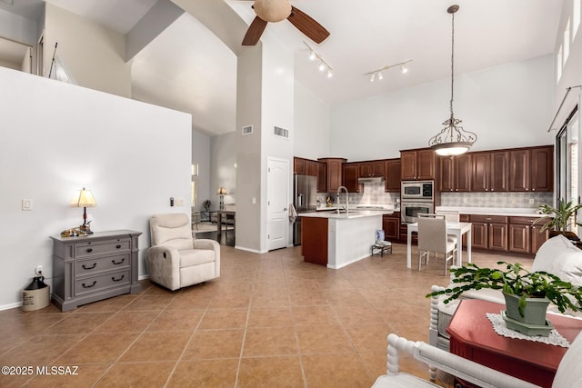 7397 W Crimson Ridge Dr, Marana, AZ 85743 - living area featuring high vaulted ceiling, ceiling fan, rail lighting, and light tile patterned flooring