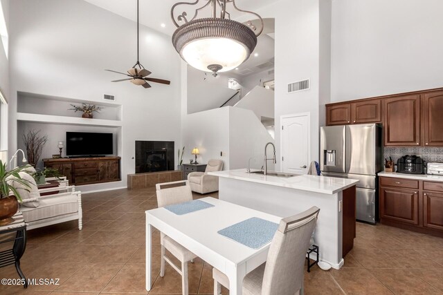 7397 W Crimson Ridge Dr, Marana, AZ 85743 - kitchen featuring stainless steel fridge, a high ceiling, ceiling fan, light countertops, and tile patterned floors