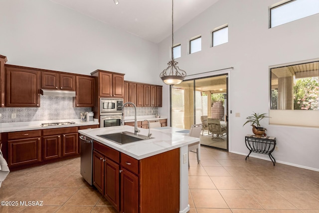 7397 W Crimson Ridge Dr, Marana, AZ 85743 - kitchen featuring stainless steel appliances, high vaulted ceiling, light countertops, light tile patterned floors, and under cabinet range hood