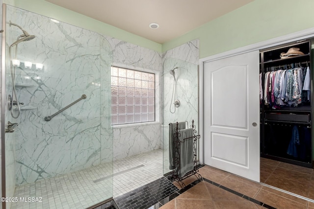 7397 W Crimson Ridge Dr, Marana, AZ 85743 - bathroom featuring a marble finish shower, tile patterned flooring, and a walk in closet