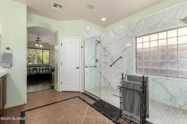 7397 W Crimson Ridge Dr, Marana, AZ 85743 - ensuite bathroom featuring a marble finish shower, vanity, tile patterned flooring, ceiling fan, and recessed lighting