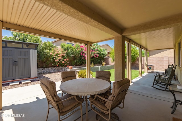 7397 W Crimson Ridge Dr, Marana, AZ 85743 - fenced backyard featuring a patio area, a shed, and outdoor dining area