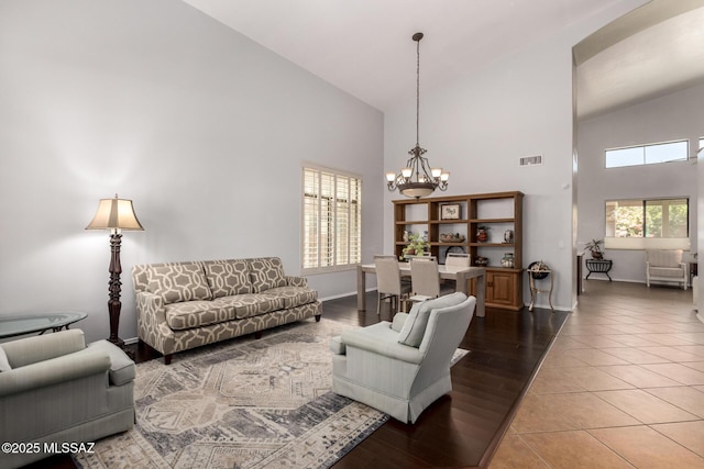 7397 W Crimson Ridge Dr, Marana, AZ 85743 - living room with high vaulted ceiling, a chandelier, and light wood-style flooring