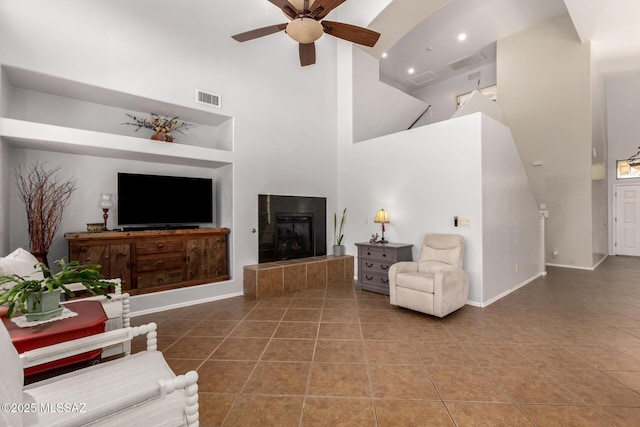 7397 W Crimson Ridge Dr, Marana, AZ 85743 - tiled living area with a towering ceiling, a ceiling fan, and a tile fireplace