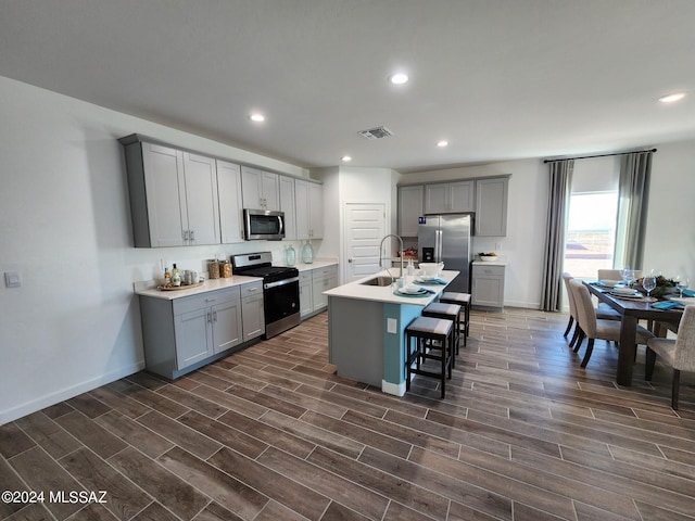 14139 E Canidae Dr E, Vail, AZ 85641 - kitchen with stainless steel appliances, gray cabinets, a sink, dark wood-style flooring, and recessed lighting