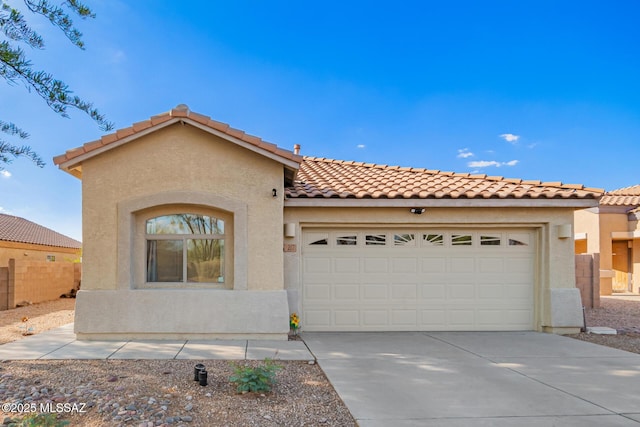 217 E Creosote Draw Rd, Vail, AZ 85641 - mediterranean / spanish-style home featuring a tiled roof, stucco siding, driveway, and a garage
