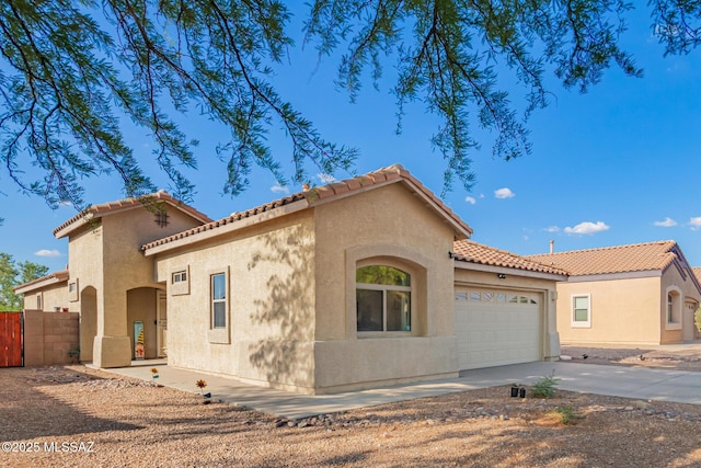 217 E Creosote Draw Rd, Vail, AZ 85641 - mediterranean / spanish house with a garage, driveway, stucco siding, and a tile roof