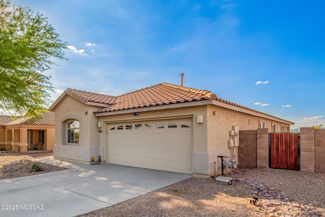 217 E Creosote Draw Rd, Vail, AZ 85641 - mediterranean / spanish house with stucco siding, an attached garage, driveway, and a tiled roof