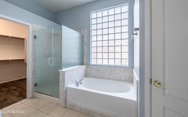 8892 N Silver Moon Way, Tucson, AZ 85743 - bathroom featuring a bath, a stall shower, a spacious closet, and tile patterned floors
