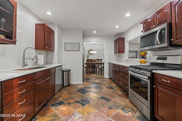 3357 N Christmas Ave, Tucson, AZ 85716 - kitchen featuring stainless steel appliances, a sink, light countertops, recessed lighting, and dark stone finish flooring