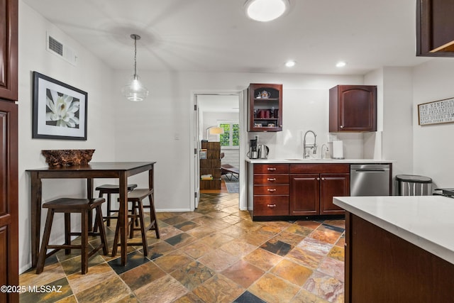 3357 N Christmas Ave, Tucson, AZ 85716 - kitchen featuring stainless steel dishwasher, light countertops, stone tile flooring, recessed lighting, and a sink