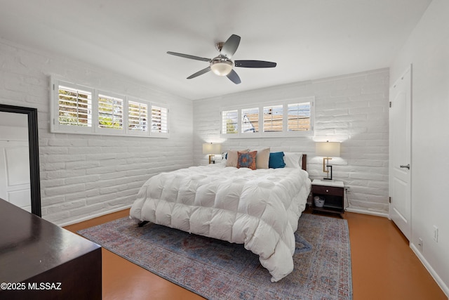 3357 N Christmas Ave, Tucson, AZ 85716 - bedroom with multiple windows, ceiling fan, brick wall, and wood finished floors