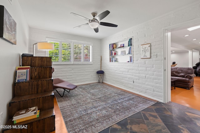 3357 N Christmas Ave, Tucson, AZ 85716 - living area with ceiling fan, stone finish flooring, and brick wall
