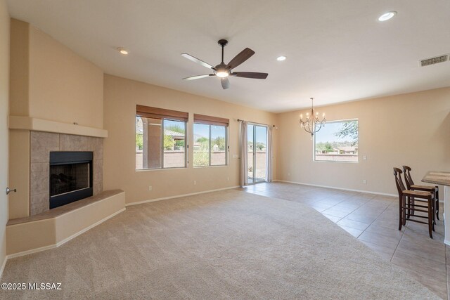 3259 E Corte Doce Palomas, Tucson, AZ 85718 - unfurnished living room with a chandelier, a ceiling fan, a fireplace, baseboards, and light tile patterned flooring