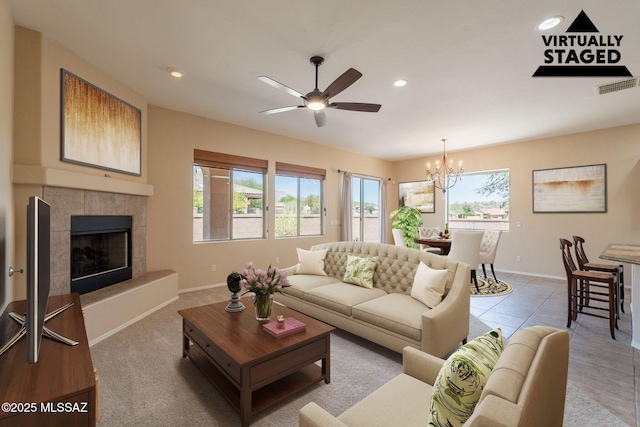 3259 E Corte Doce Palomas, Tucson, AZ 85718 - living room with a chandelier, a ceiling fan, baseboards, recessed lighting, and a fireplace