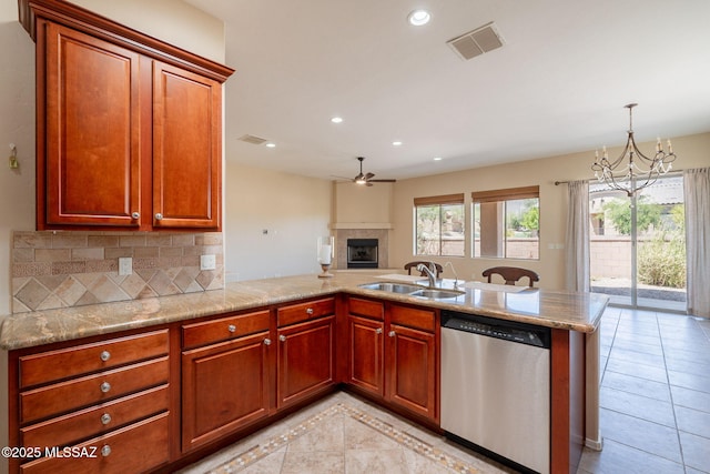 3259 E Corte Doce Palomas, Tucson, AZ 85718 - kitchen featuring stainless steel dishwasher, a sink, a peninsula, open floor plan, and a chandelier