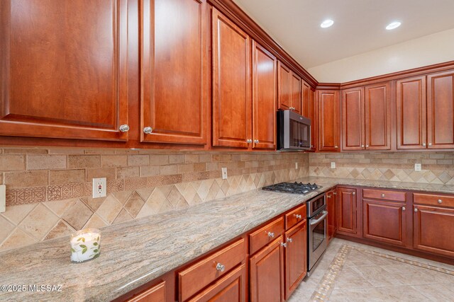 3259 E Corte Doce Palomas, Tucson, AZ 85718 - kitchen featuring stainless steel appliances, inlaid floor details, light stone counters, decorative backsplash, and recessed lighting