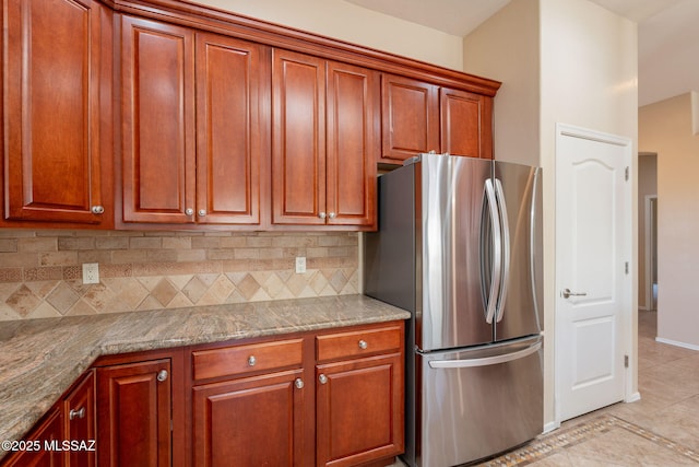 3259 E Corte Doce Palomas, Tucson, AZ 85718 - kitchen featuring freestanding refrigerator, tasteful backsplash, light tile patterned flooring, and stone counters