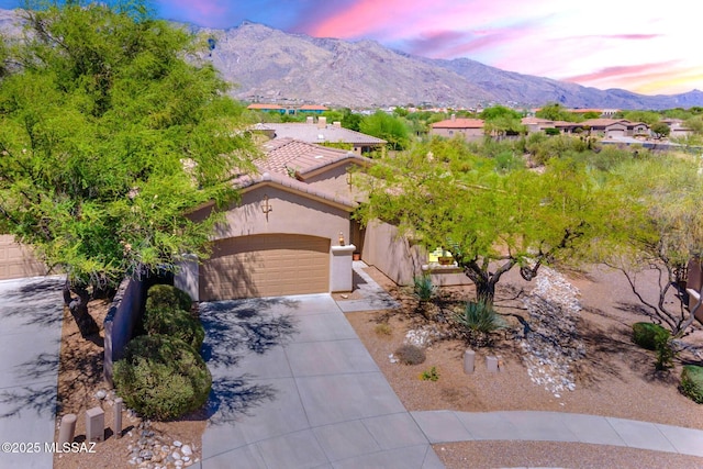 3259 E Corte Doce Palomas, Tucson, AZ 85718 - view of front facade with concrete driveway, stucco siding, an attached garage, a mountain view, and a tile roof