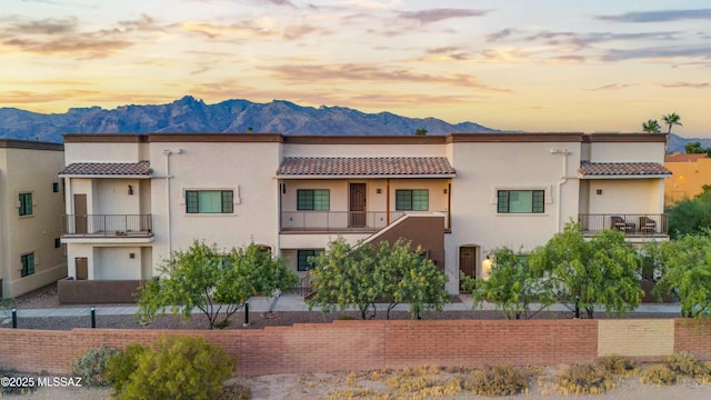 2020 E River Rd Unit 205, Tucson, AZ 85718 - view of front of home featuring a mountain view, stucco siding, a balcony, and a tile roof