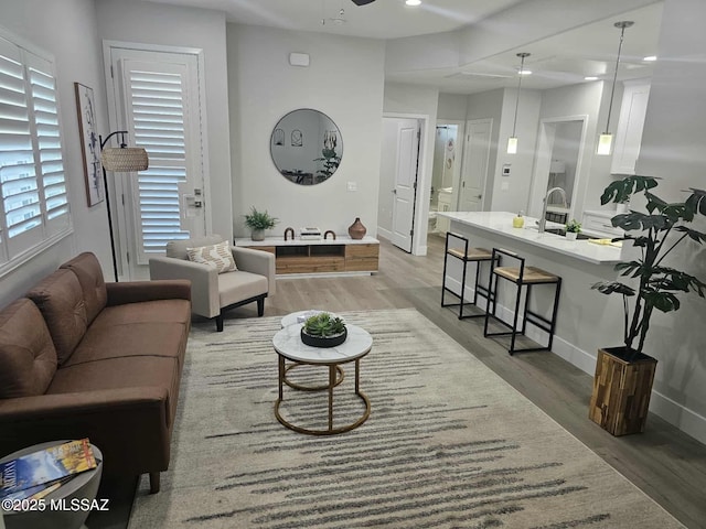 2020 E River Rd Unit 205, Tucson, AZ 85718 - living room featuring light wood-style flooring, baseboards, a ceiling fan, and recessed lighting