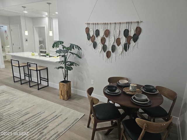 2020 E River Rd Unit 205, Tucson, AZ 85718 - dining space featuring light wood-type flooring and baseboards