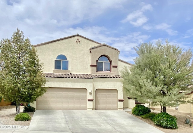 9828 N Niobrara Way, Tucson, AZ 85742 - mediterranean / spanish-style home featuring an attached garage, stucco siding, a tile roof, and concrete driveway