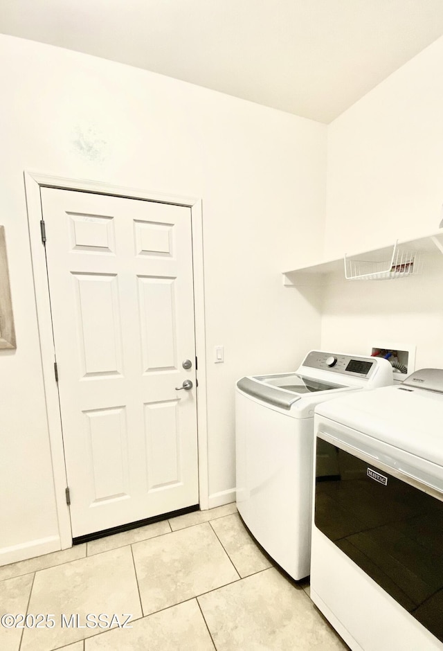 9828 N Niobrara Way, Tucson, AZ 85742 - laundry room with washer and dryer, light tile patterned flooring, and baseboards