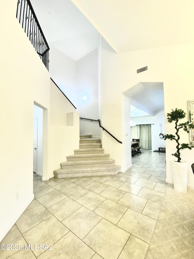 9828 N Niobrara Way, Tucson, AZ 85742 - stairs with a towering ceiling and tile patterned flooring