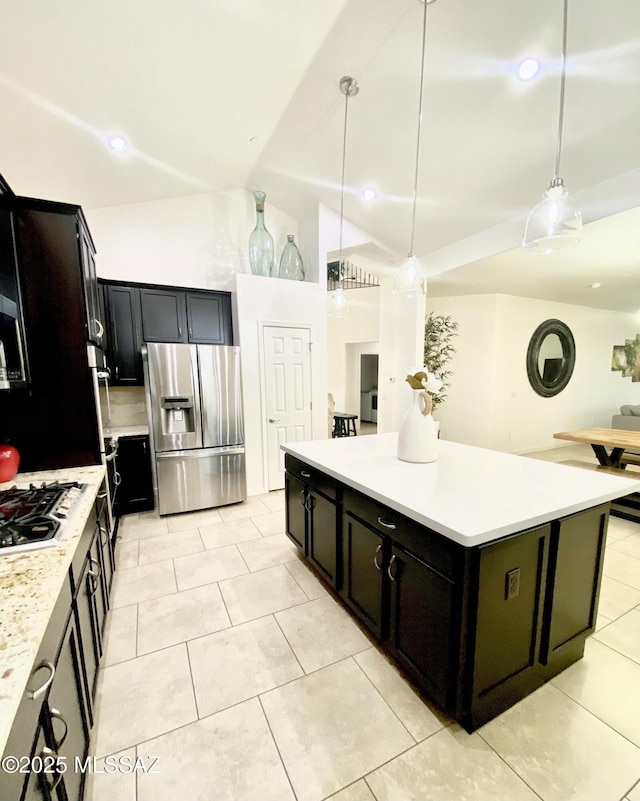 9828 N Niobrara Way, Tucson, AZ 85742 - kitchen featuring stainless steel appliances, vaulted ceiling, light countertops, light tile patterned floors, and a kitchen island