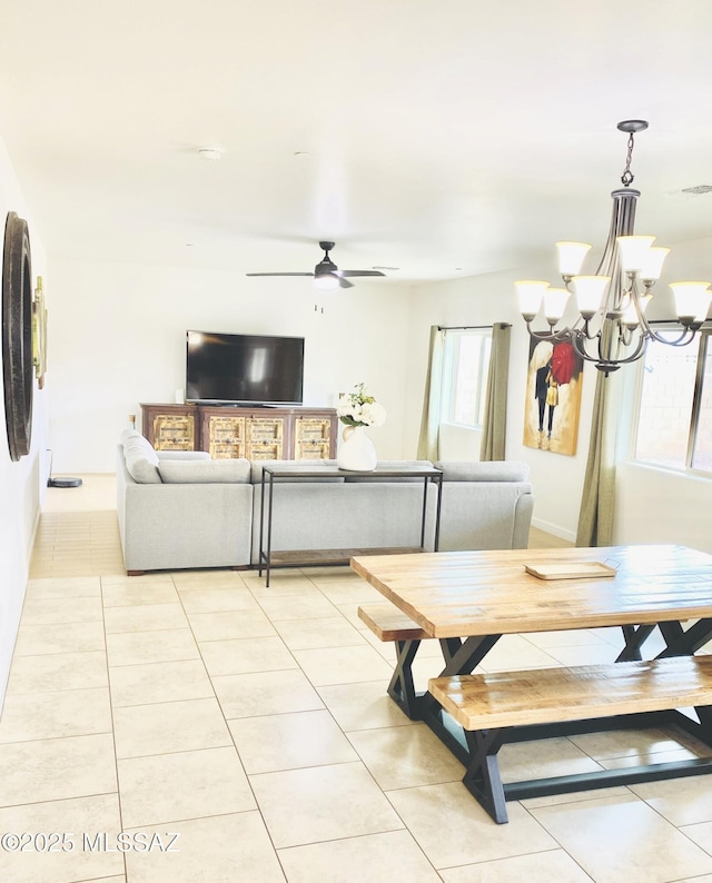 9828 N Niobrara Way, Tucson, AZ 85742 - dining area featuring light tile patterned flooring, a ceiling fan, a chandelier, and baseboards