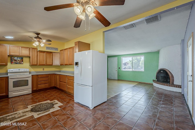 7821 N Jensen Dr, Tucson, AZ 85741 - kitchen with white appliances, ceiling fan, dark tile patterned flooring, and light countertops