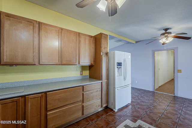 7821 N Jensen Dr, Tucson, AZ 85741 - kitchen featuring white refrigerator with ice dispenser, ceiling fan, light countertops, and brown cabinetry